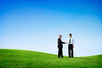 Two Businessmen Having an Agreement in an Open Field