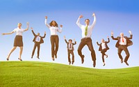 Business people jumping up on a hill