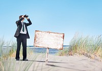 Businessman Holding Megatelescope with Empty Signboard on Beach