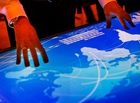 Hands touching a cyber space table screen