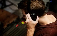 A man listen to headphone checking the sound