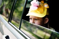 Young girl sitting inside a car