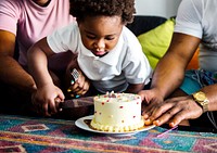 Black family cutting birthday cake