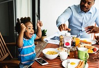 Black family having breakfast together