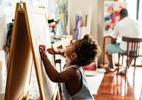 Black kid enjoying his painting