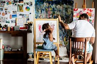 African descent artist dad giving his child a high five