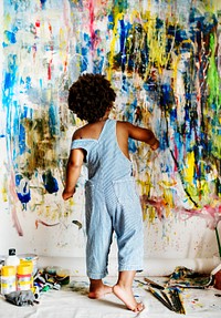 Black kid enjoying his painting