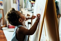 Black kid enjoying his painting