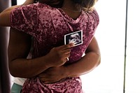 Black couple with baby ultrasound scan photo