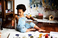 Black kid enjoying his painting