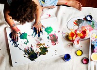 Black kid enjoying his painting