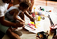 Black kid enjoying color painting