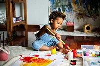 Black kid enjoying his painting