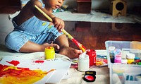 Black kid enjoying his painting
