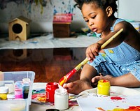 Black kid enjoying color painting