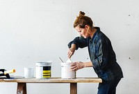 Woman standing holding mix a color in a can