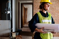 Construction woman holding blueprint