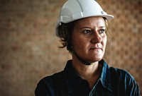 Woman constructor wearing hard helmet