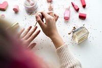 Woman with pink hair doing nail polish
