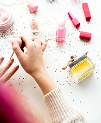 Woman with pink hair doing nail polish