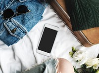 Lifestyle woman sitting with clothing and smart phone