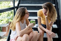 Two Caucasian women sitting and talking together