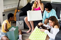 Women showing friends shopping items