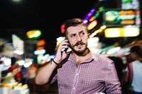 Man talking on the phone at street night market