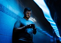 Closeup of a man using mobile phone in the dark with long exposure light