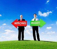 Two Businessmen Holding Contrasting Arrows for Wrong and Right