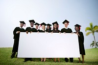 Group Graduating Students Outdoors Holding Placard Concept