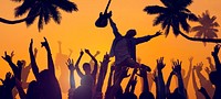 Silhouettes of People Enjoying a Concert on the Beach