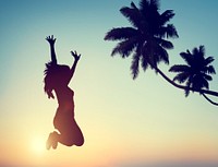 Silhouette of a Young Woman Jumping with Excitement