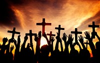 Group of People Holding Cross and Praying in Back Lit Concept