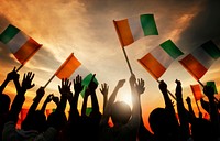 Silhouettes of People Holding Flag of Ireland