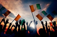 Silhouettes of People Holding Flag of Ireland