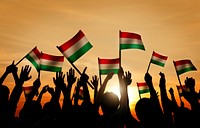 Silhouettes of People Holding the Flag of Hungary