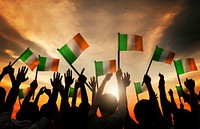 Silhouettes of People Waving the Flag of Ireland