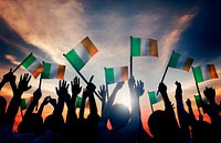 Silhouettes of People Waving the Flag of Ireland