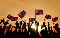 Group of People Waving Mongolian Flags in Back Lit
