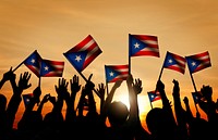 Group of People Waving Flag of Puerto Rico in Back Lit