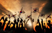 Group of People Waving South Korea Flags in Back Lit