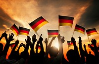 Silhouettes of People Holding Flag of Germany