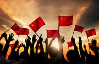 Silhouettes of People Holding the Flag of China