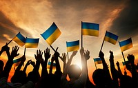 Group of People Waving Ukranian Flags in Back Lit