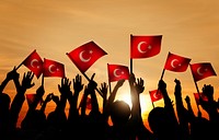 Silhouettes of People Holding the Flag of Turkey