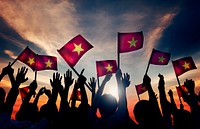 Group of People Waving Vietnamese Flags in Back Lit