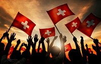 Silhouettes of People Holding Flag of Switzerland