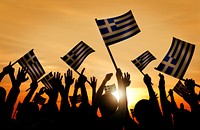 Silhouettes of People Holding Flag of Greece