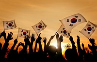Silhouettes of People Holding Flag of South Korea